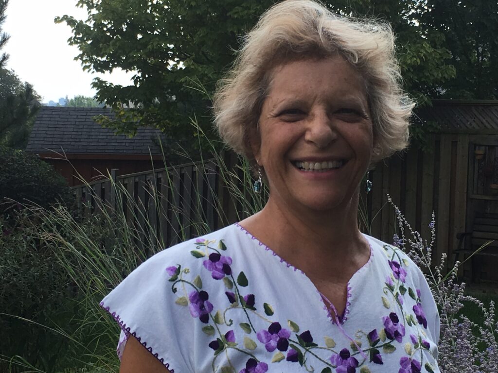 Adela standing outside smiling.