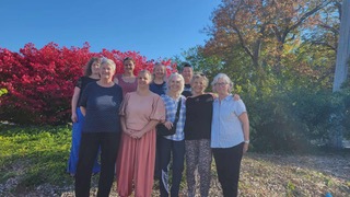 A group of people posing outside together.