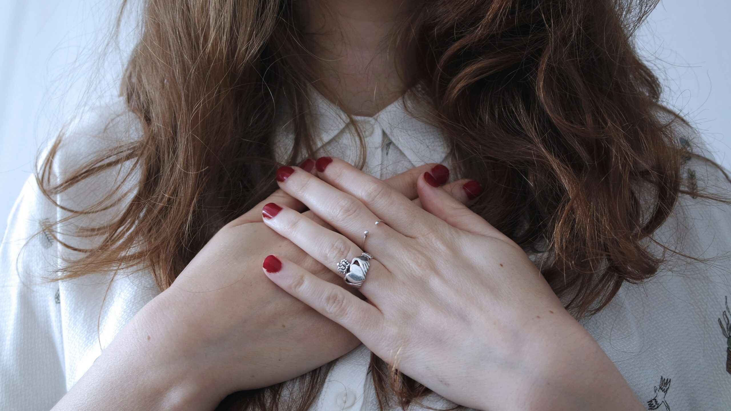A woman with her hands on her heart.
